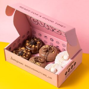 Pink donut box for bakery takeaway packaging with assorted donuts