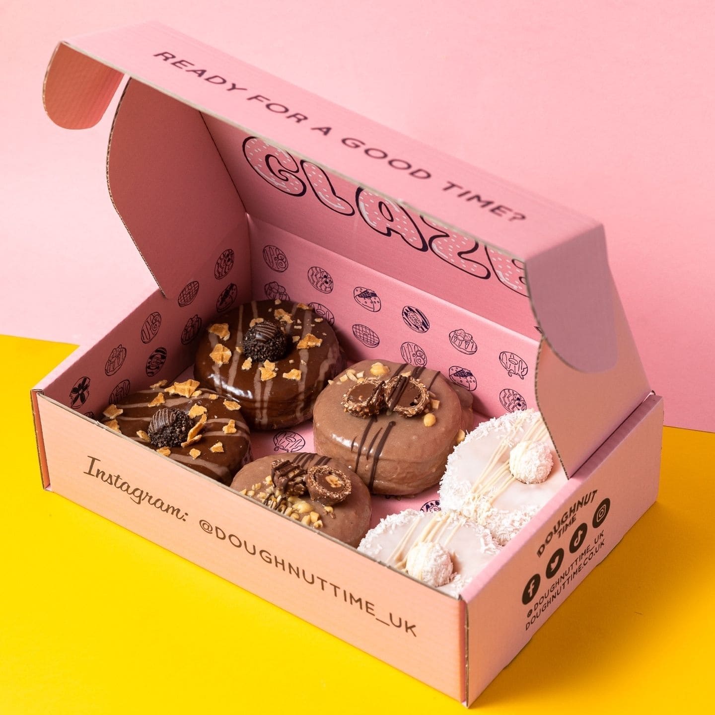 Pink donut box for bakery takeaway packaging with assorted donuts