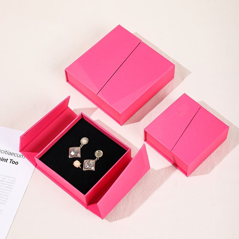 Pink drawer-style paper jewelry box with black insert