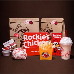 Custom restaurant fried chicken packaging display with boxes, bag, fries carton and drink cup